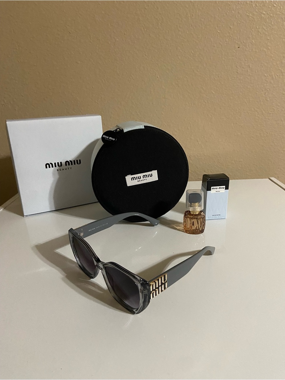 Miu Miu Gray Cat-Eye Sunglasses with Gold Temple Accents